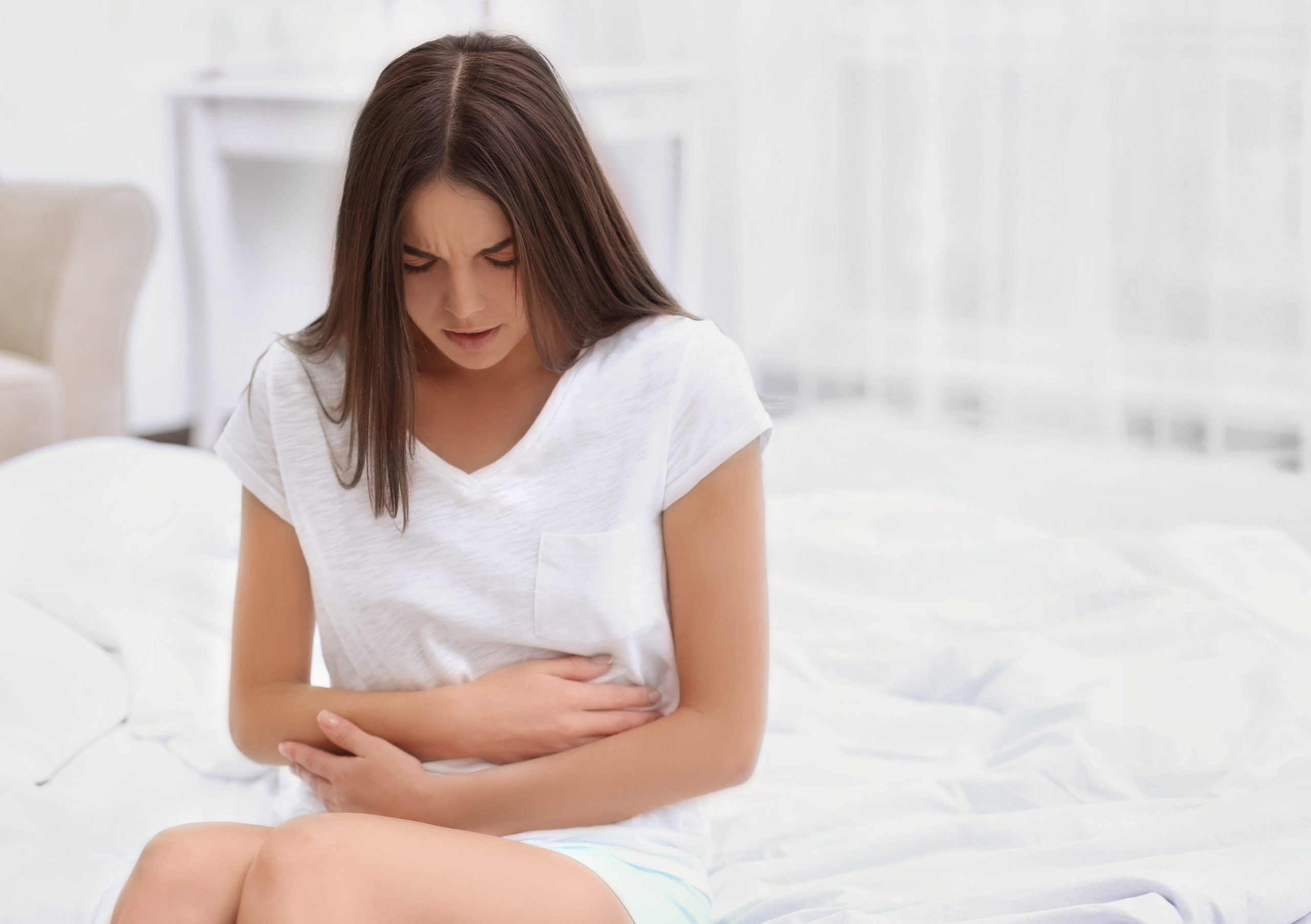 Young woman suffering from abdominal pain due to endometriosis